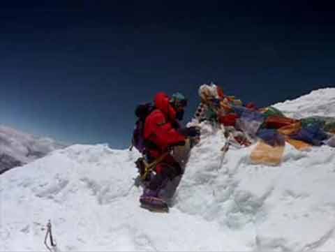 
Jamling Tenzing Norgay putting pictures of his family and the Dalai Lama on the Everest summit May 23, 1996 - IMAX Everest DVD

